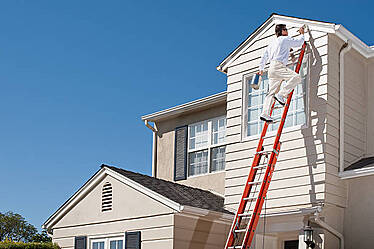 Image of a painter painting a home